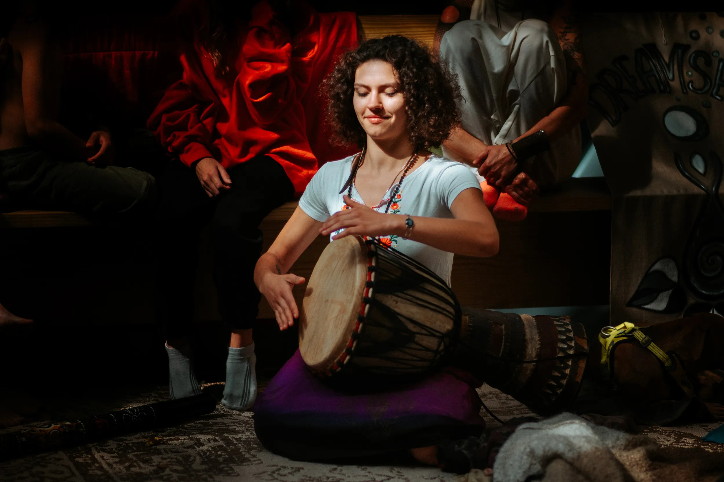 Woman playing a hand drum at a retreat