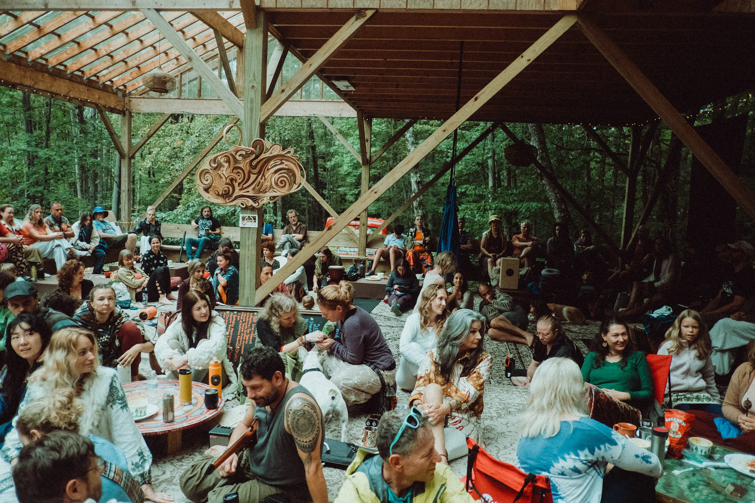 Retreat participants gathered under a wooden pavilion