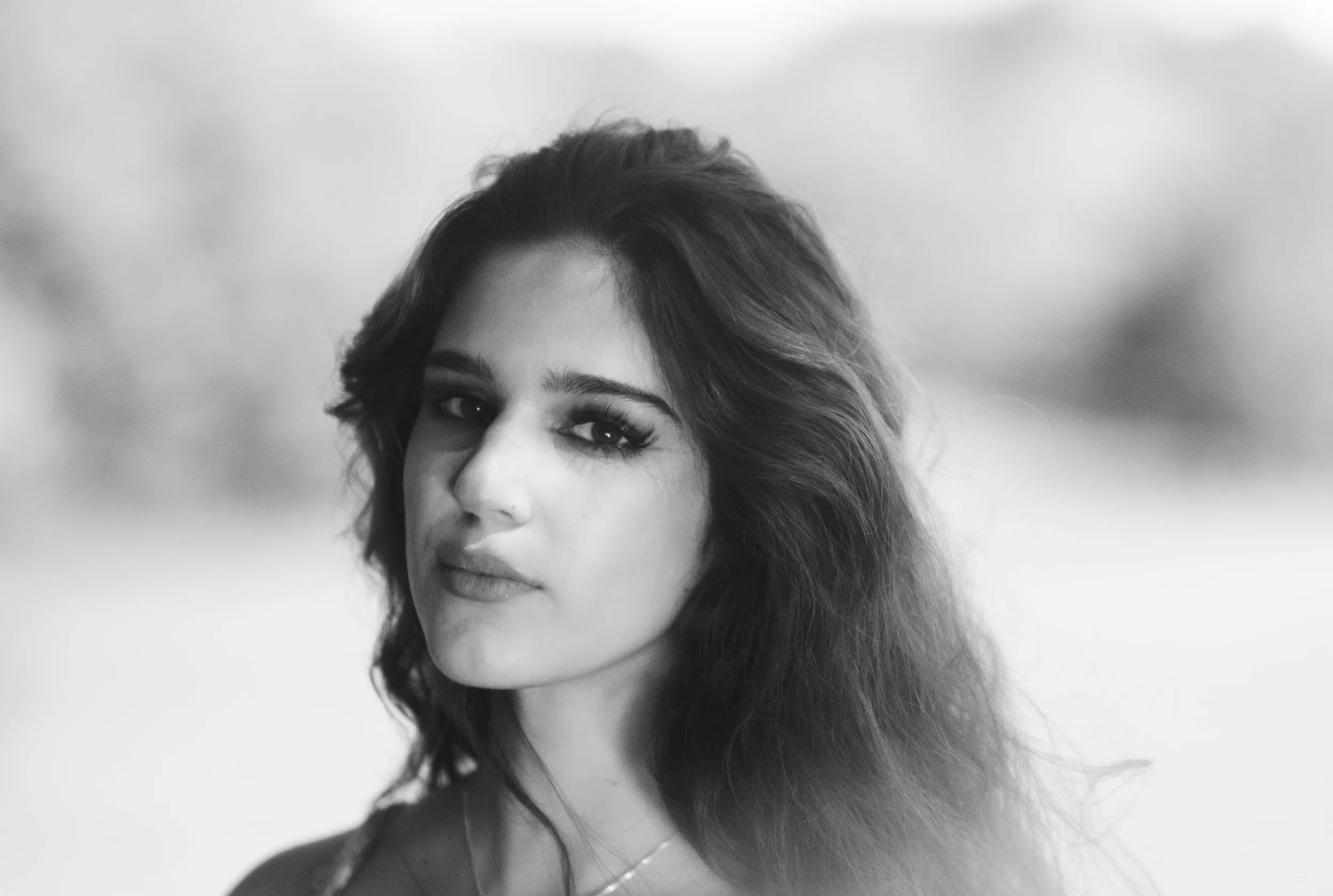 Black-and-white outdoor portrait of a young woman